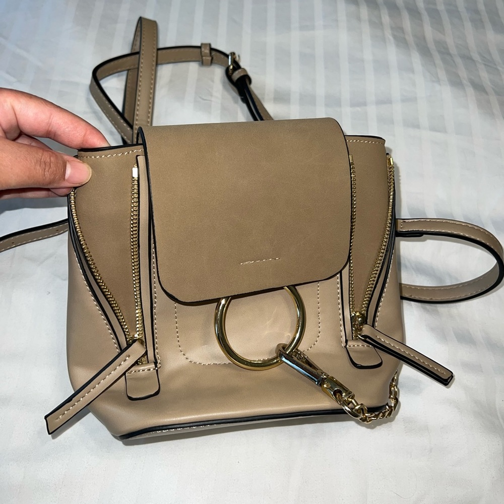 Small tan faux leather backpack.